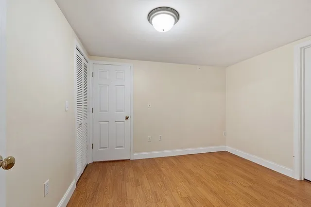 a view of a room with wooden floor and natural light