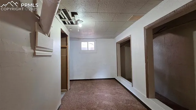 a view of hallway with stairs and wooden floor
