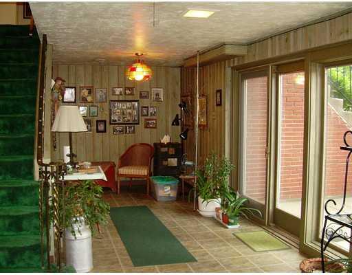 2227 Harmain Road Churchill, PA 15235 - Photo 13 of 18 Family Room. Part of the L-shaped family room, has a wall of glass and access to a small front patio.