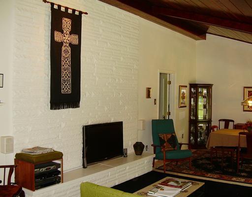 2227 Harmain Road Churchill, PA 15235 - Photo 5 of 18 Living Room. A sleeck decorative fireplace accents the stone wall.