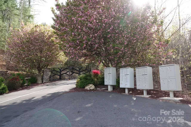 a street sign on a wall next to a road