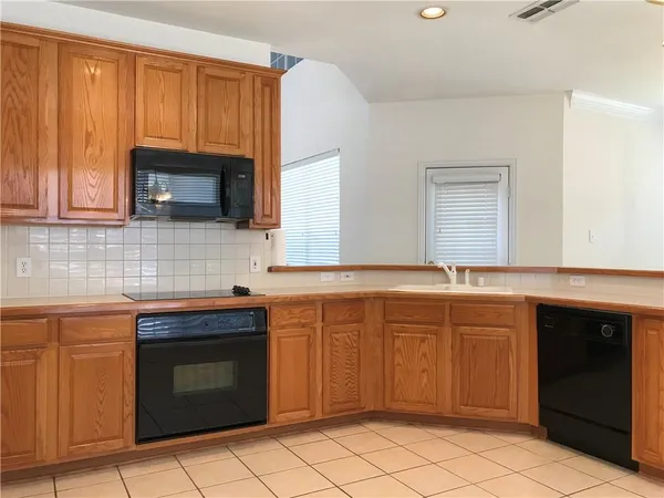 a kitchen with a sink stove and microwave