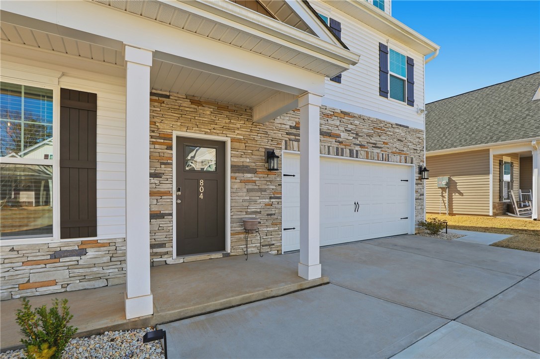 804 Spring Orchard Drive Lyman, SC 29365 - Photo 12 of 47 This charming home showcases a stone facade and a welcoming entryway with an attached garage.