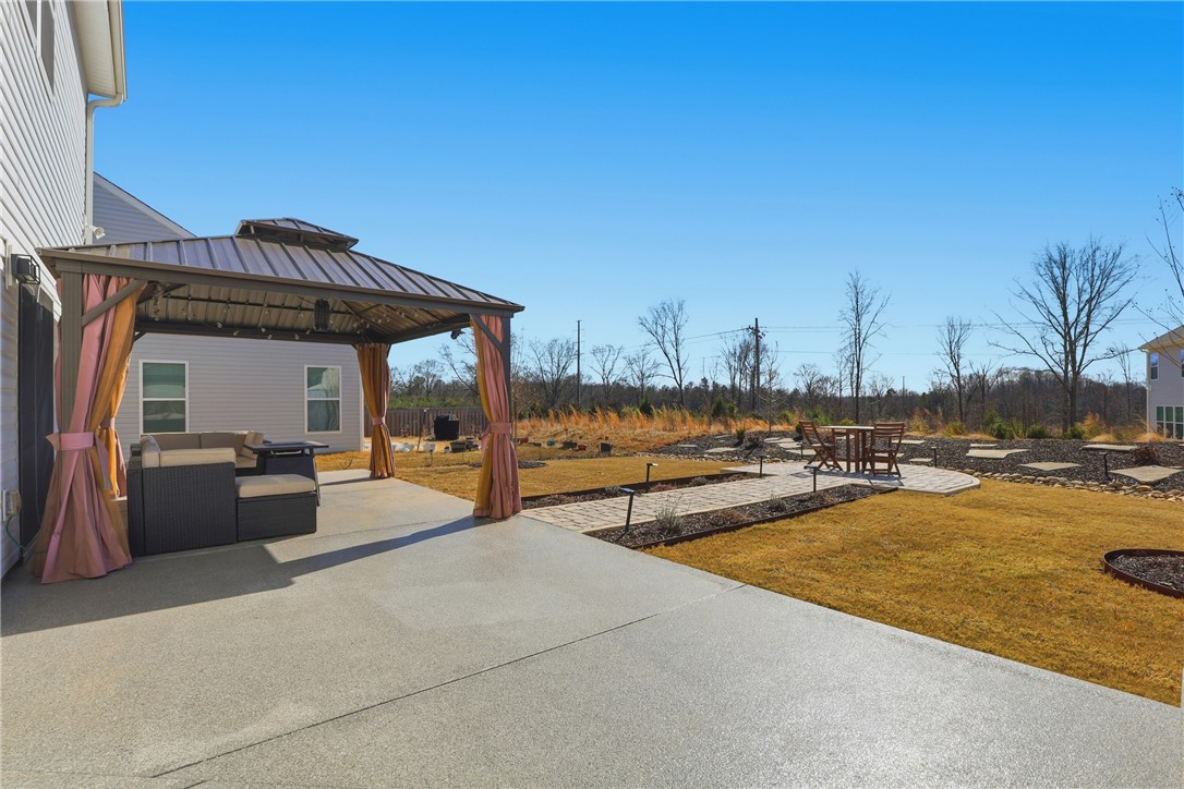 804 Spring Orchard Drive Lyman, SC 29365 - Photo 2 of 47 Why settle for just sod - when you have this?! Enjoy outdoor gatherings on the spacious patio with a stylish gazebo, extended patio, walkout, sidewalk, professional landscaping and ample backyard space.