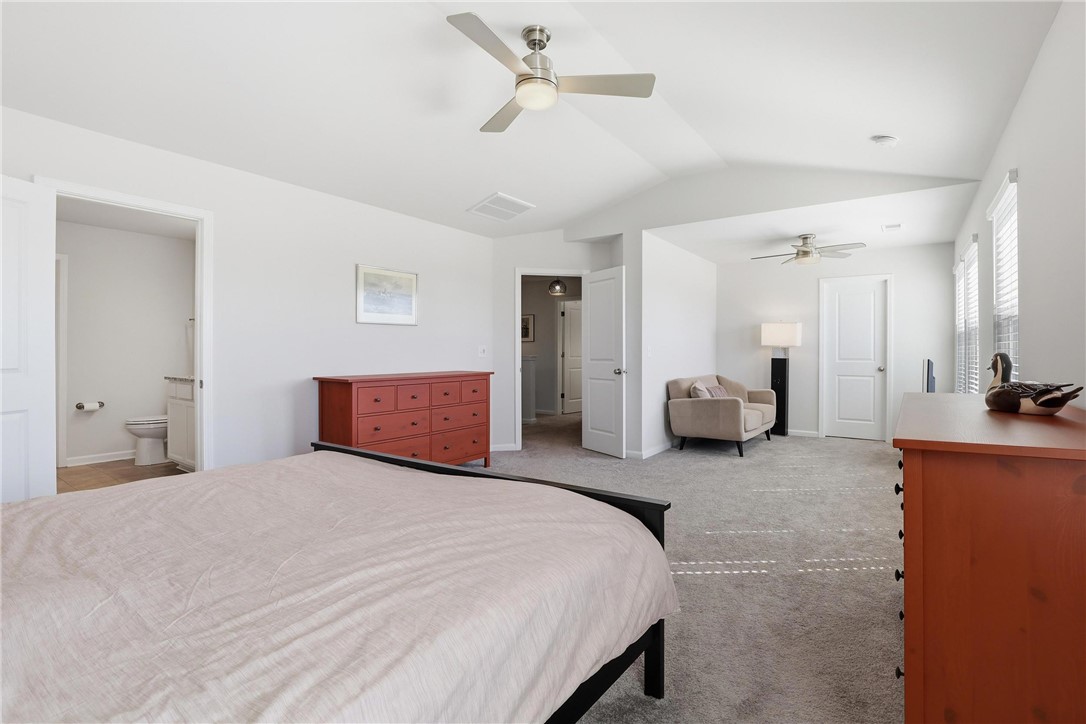 804 Spring Orchard Drive Lyman, SC 29365 - Photo 22 of 47 This spacious primary bedroom features soft carpeting, ample natural light, and convenient access to an en-suite bathroom.