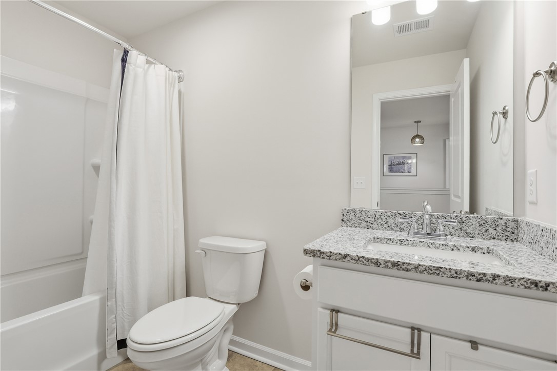 804 Spring Orchard Drive Lyman, SC 29365 - Photo 28 of 47 This bright bathroom features a vanity with granite counters and an inviting shower and tub combination.