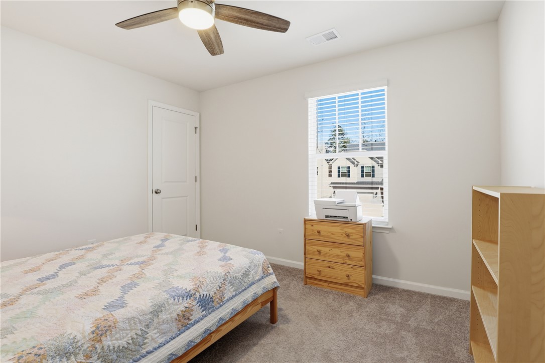 804 Spring Orchard Drive Lyman, SC 29365 - Photo 28 of 47 This cozy bedroom features plush carpeting and a bright window overlooking the neighborhood.