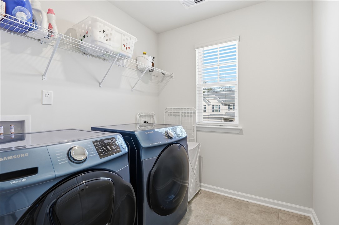 804 Spring Orchard Drive Lyman, SC 29365 - Photo 33 of 47 This laundry area features convenient storage solutions and modern appliances for efficient home management.
