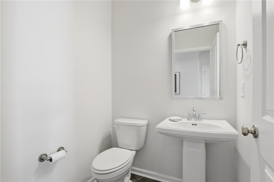 804 Spring Orchard Drive Lyman, SC 29365 - Photo 36 of 47 This modern bathroom features a sleek pedestal sink and contemporary fixtures, creating a clean aesthetic.