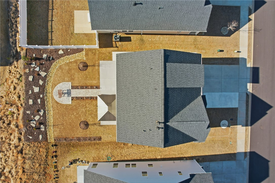 804 Spring Orchard Drive Lyman, SC 29365 - Photo 36 of 47 An aerial view showcases a house with a neatly paved patio, inviting outdoor leisure.