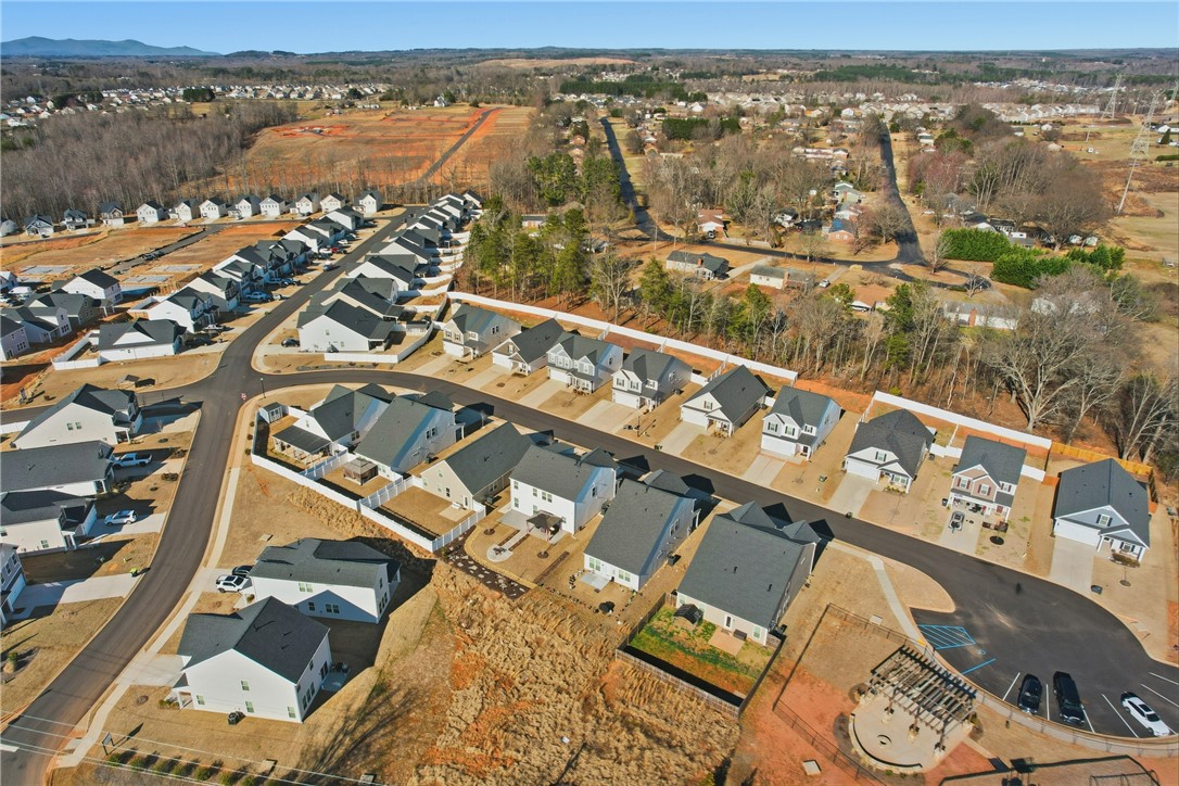 804 Spring Orchard Drive Lyman, SC 29365 - Photo 40 of 47 An aerial view captures a vibrant neighborhood featuring modern homes and a community green space.