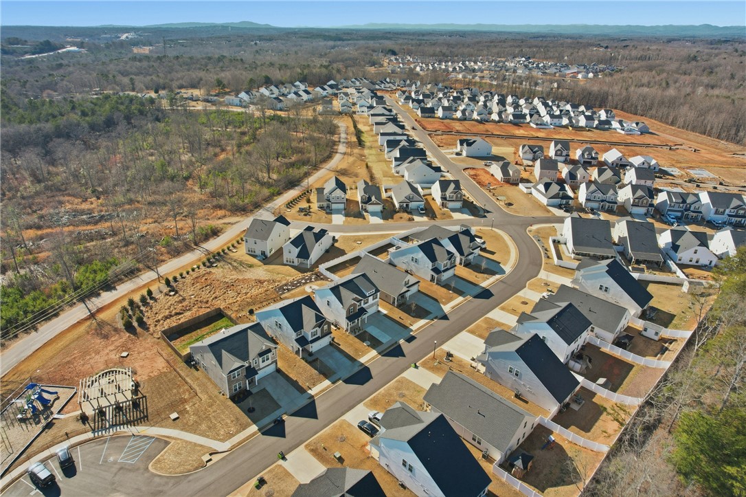 804 Spring Orchard Drive Lyman, SC 29365 - Photo 43 of 47 An aerial view captures a vibrant neighborhood featuring modern homes and abundant green spaces.