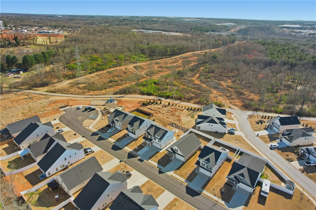 804 Spring Orchard Drive Lyman, SC 29365 - Photo 43 of 47 An aerial perspective reveals a developing residential community nestled among wooded landscapes and open terrain.