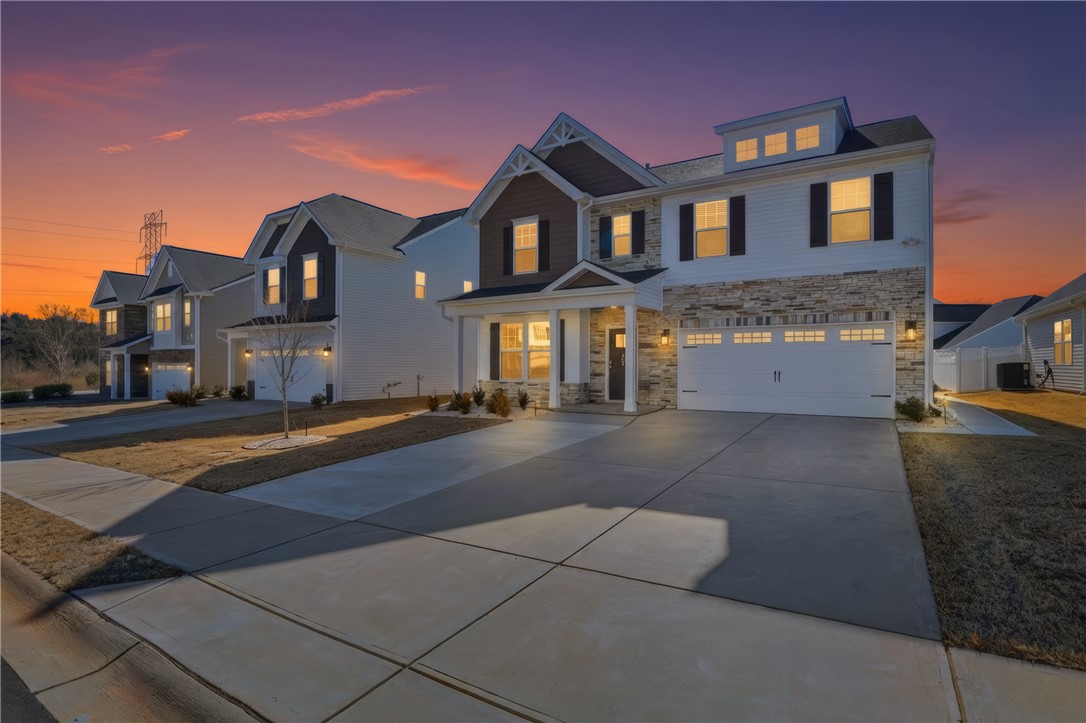 804 Spring Orchard Drive Lyman, SC 29365 - Photo 8 of 47 This modern home features a welcoming facade and convenient attached garage.