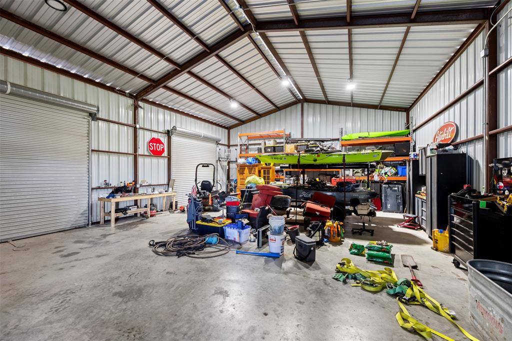 511 East Pecan Tree Road Waxahachie, TX 75165 - Photo 15 of 36 workshop/garage with electricity, concrete flooring, and three roll up doors- designed for work, storage, hobbies, and ATVS!
