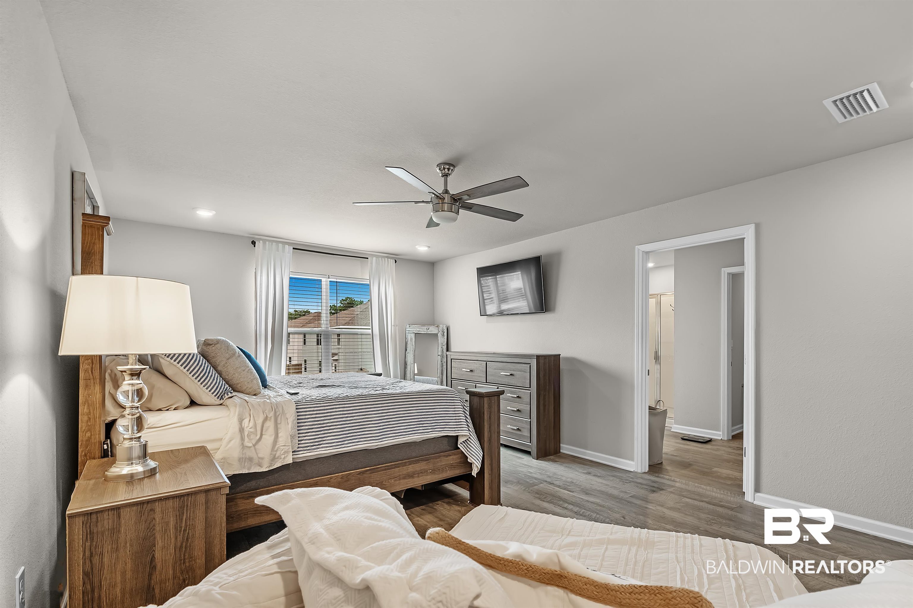 24549 Broken Sound Loop Orange Beach, AL 36561 - Photo 29 of 57 Bedroom with hardwood / wood-style flooring and ceiling fan