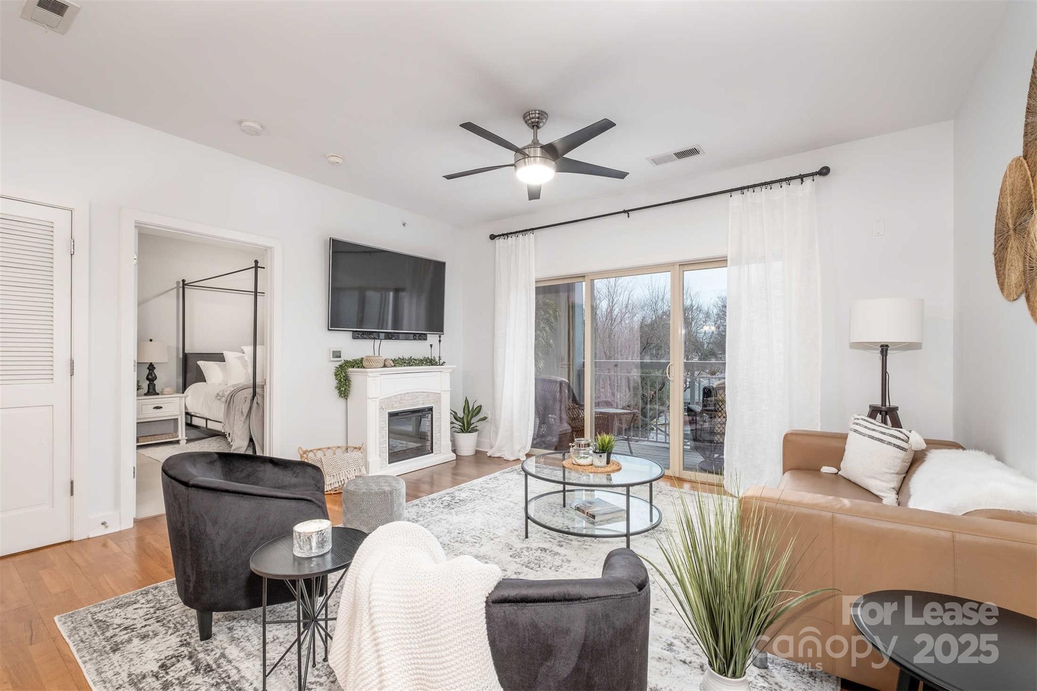 a living room with fireplace furniture and a flat screen tv