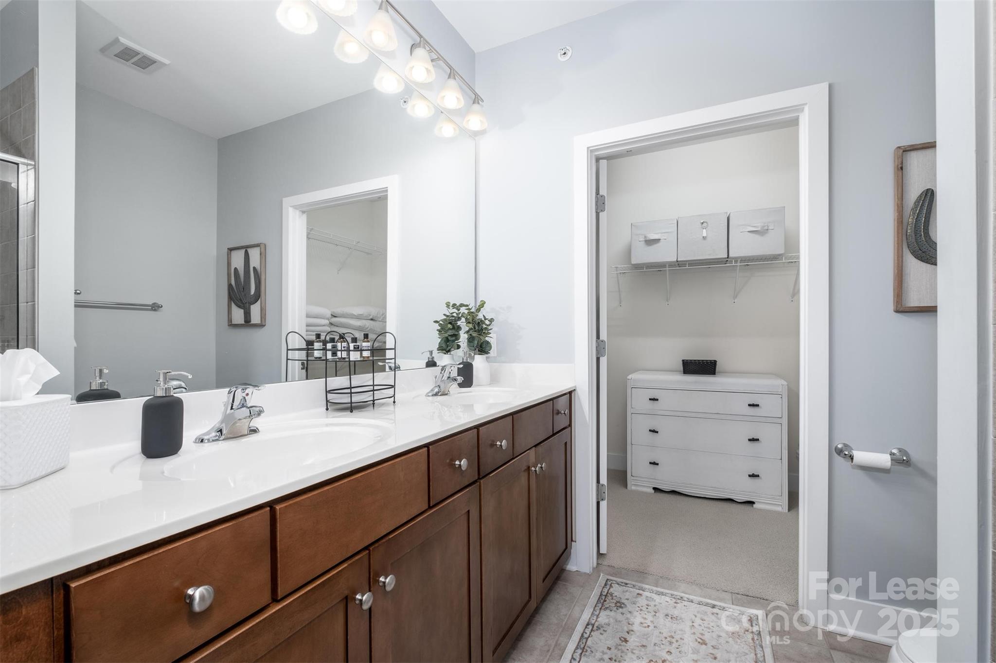 630 Calvert Street, Unit 409 Charlotte, NC 28208 - Photo 8 of 8 a bathroom with a granite countertop sink and a mirror