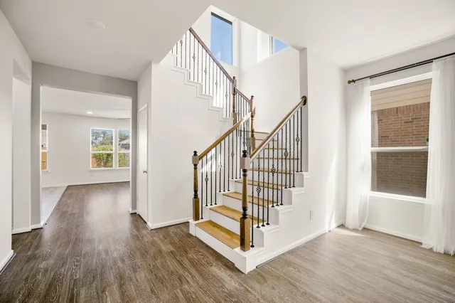 a view of entryway with wooden floor and front door