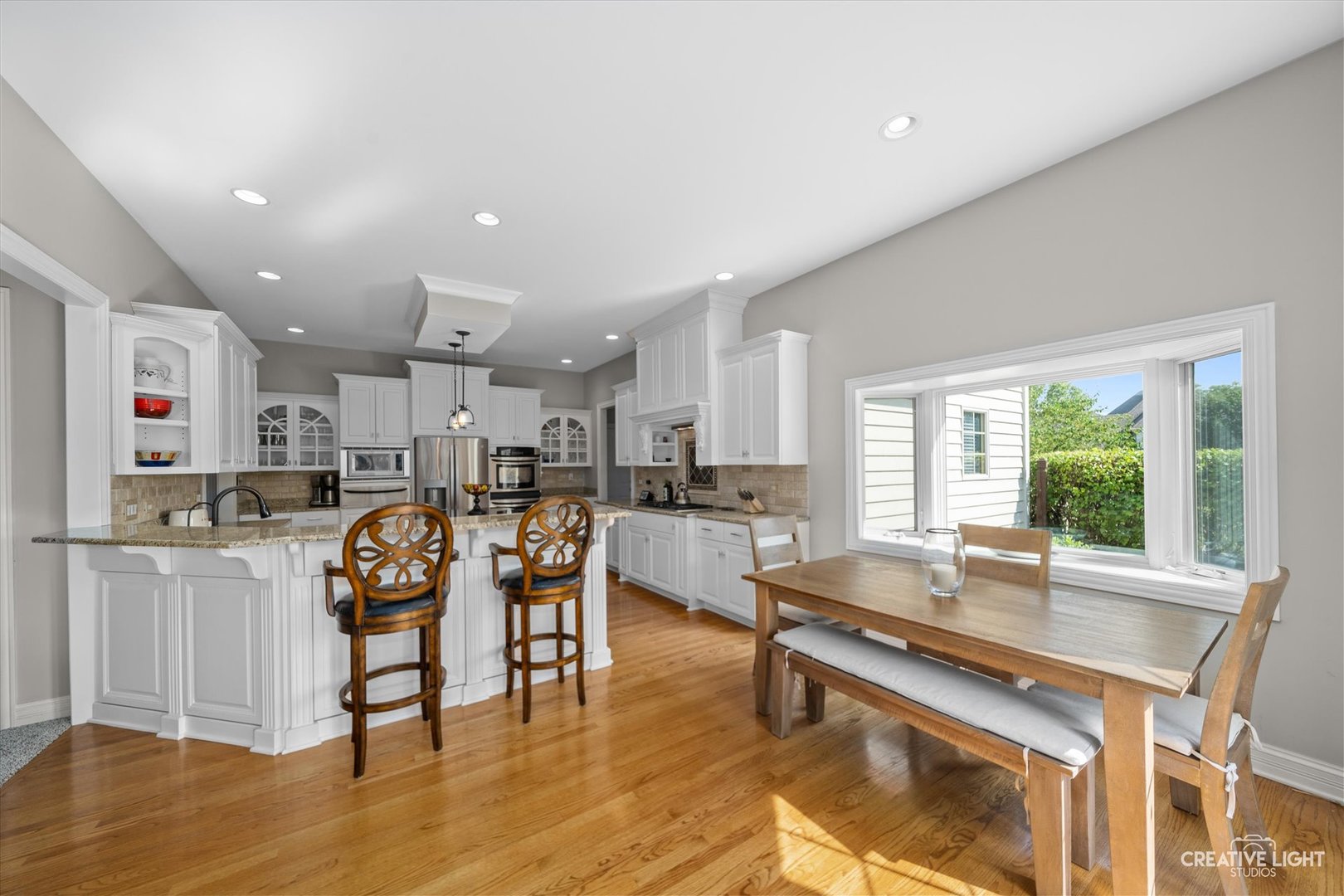 2334 Kane Lane Batavia, IL 60510 - Photo 14 of 34 a living room with stainless steel appliances kitchen island granite countertop furniture and a wooden floor