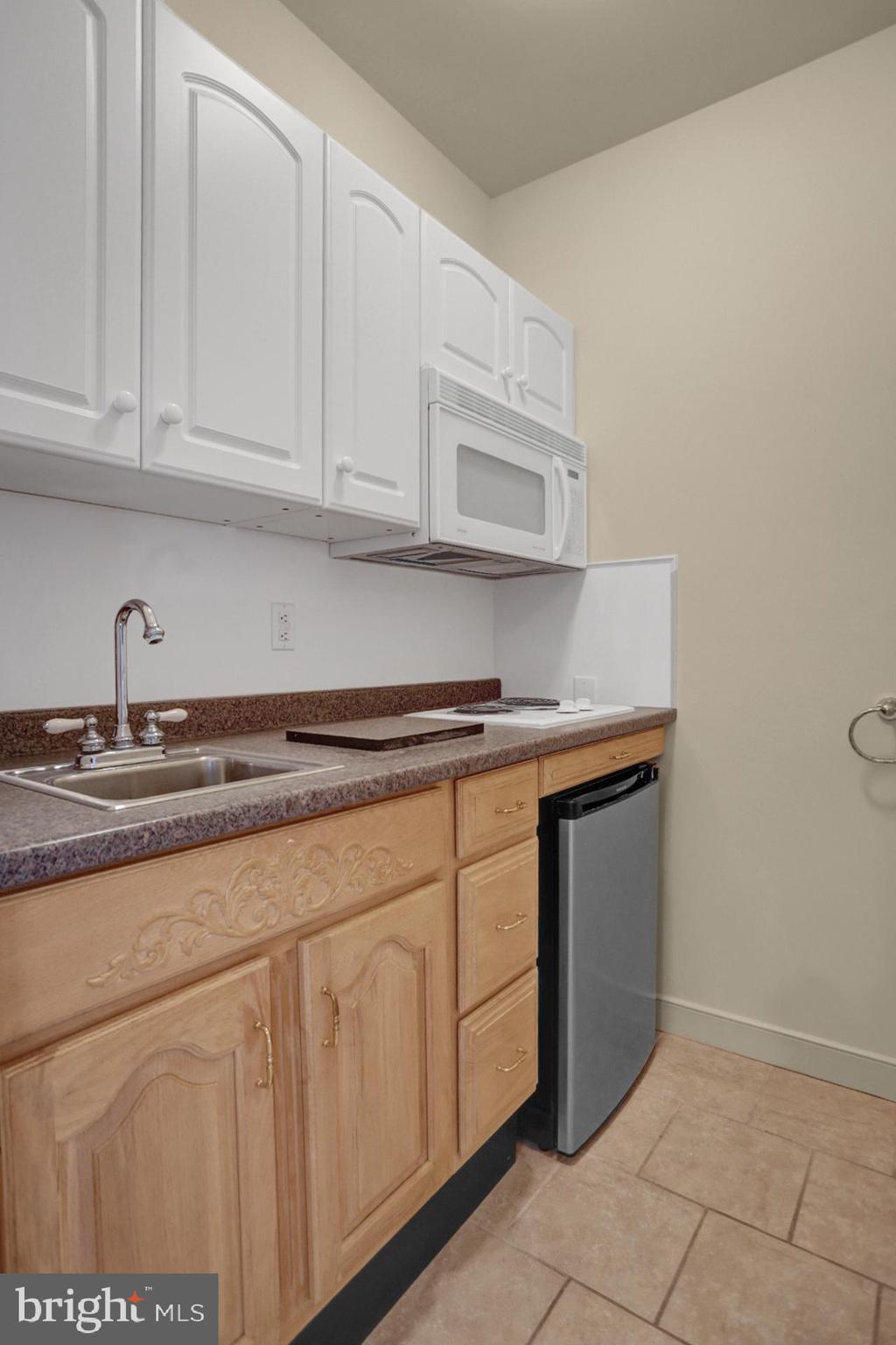 101 Robert Drive Reading, PA 19610 - Photo 104 of 118 a kitchen with granite countertop white cabinets and sink