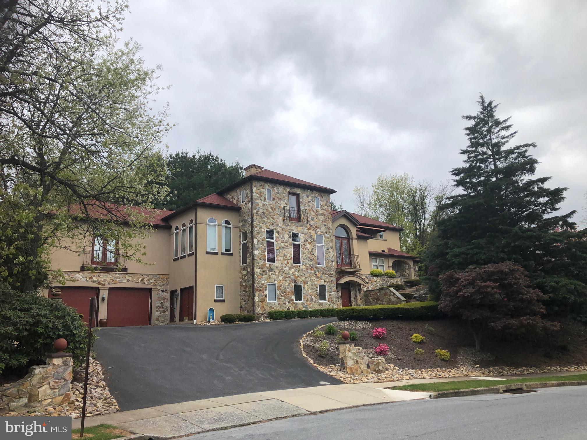 101 Robert Drive Reading, PA 19610 - Photo 12 of 118 a front view of a house with garden