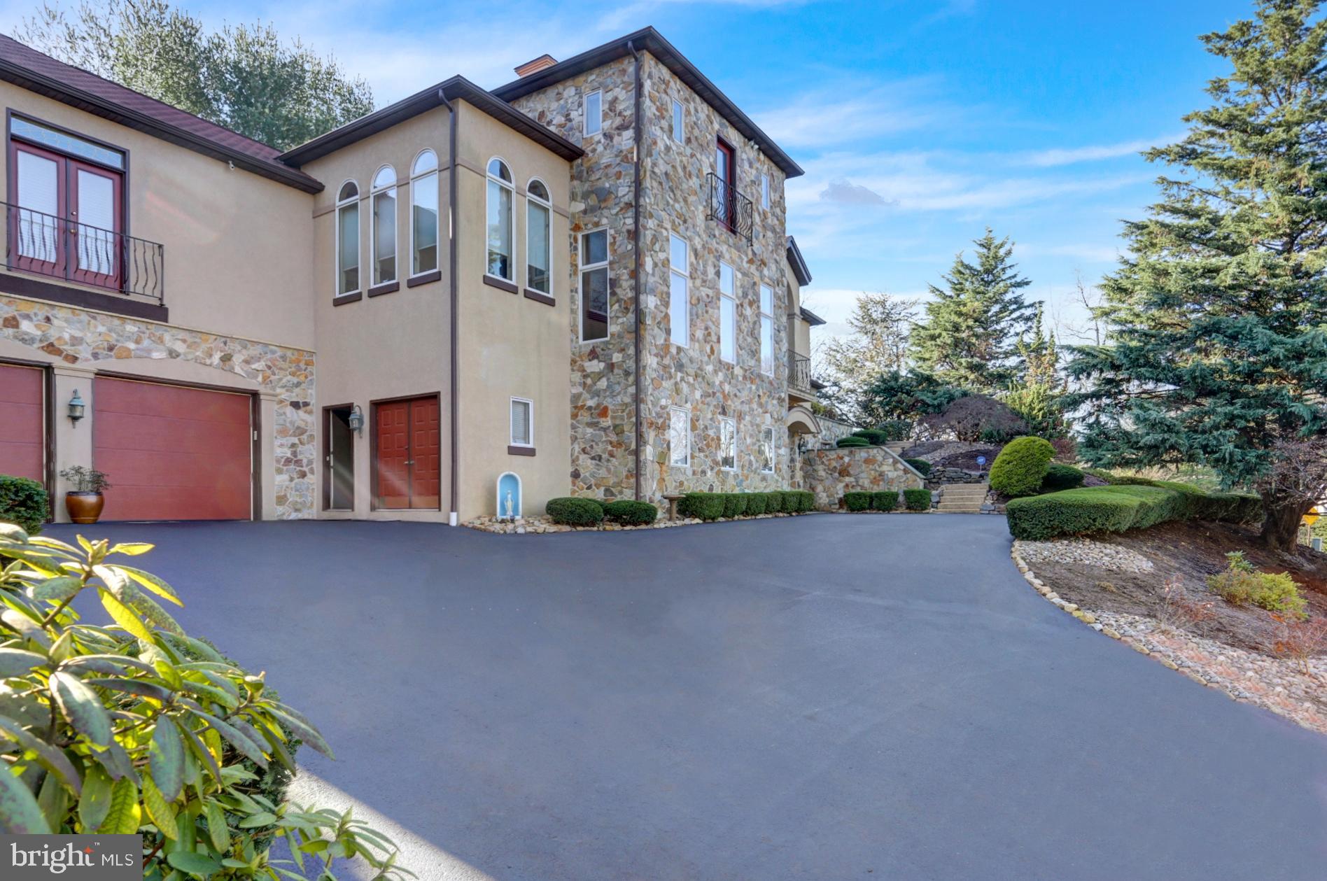 101 Robert Drive Reading, PA 19610 - Photo 5 of 118 a front view of a house with a yard and a garden