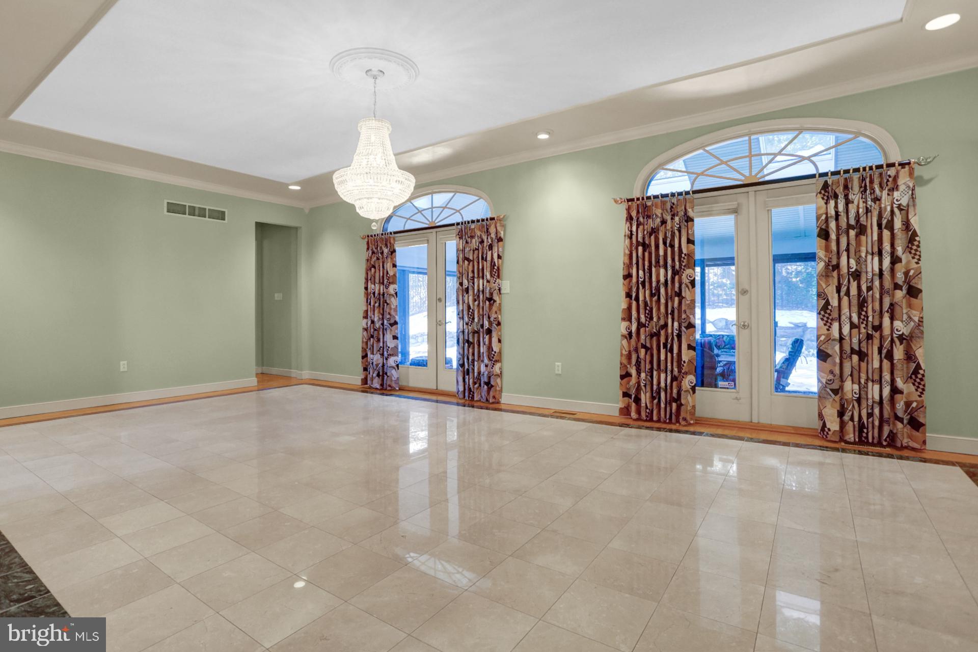 101 Robert Drive Reading, PA 19610 - Photo 62 of 118 a view of an empty room with window and chandelier