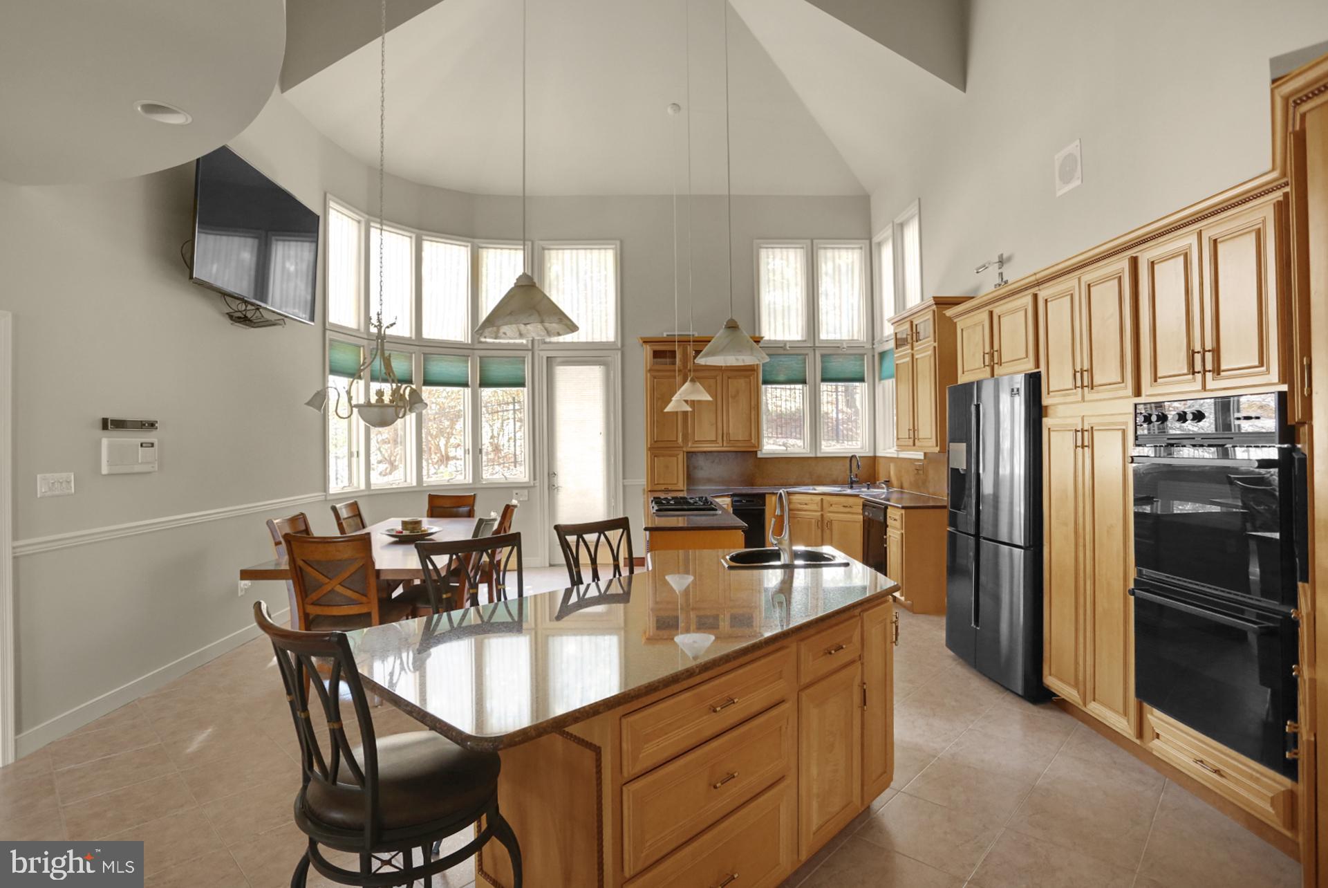 101 Robert Drive Reading, PA 19610 - Photo 77 of 118 a dining hall with stainless steel appliances granite countertop a stove a refrigerator a oven a dining table and chairs with wooden floor