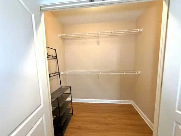 a view of a room with wooden floor and a window