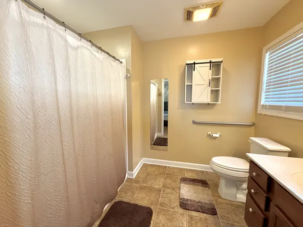 a bathroom with a toilet a sink and a shower