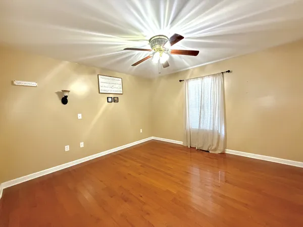 wooden floor in an empty room with a window
