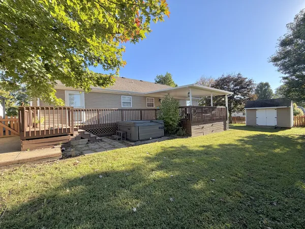 a view of a house with a yard and sitting area