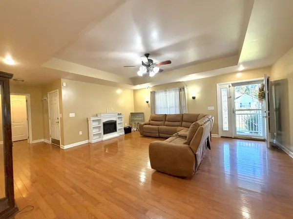 a living room with furniture fireplace and wooden floor