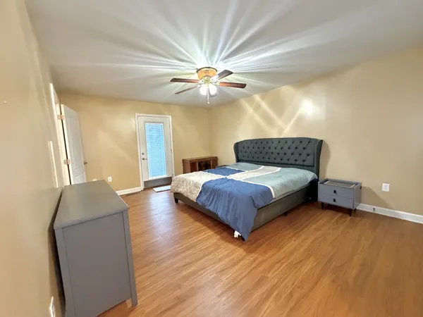 a bedroom with a bed and a chandelier
