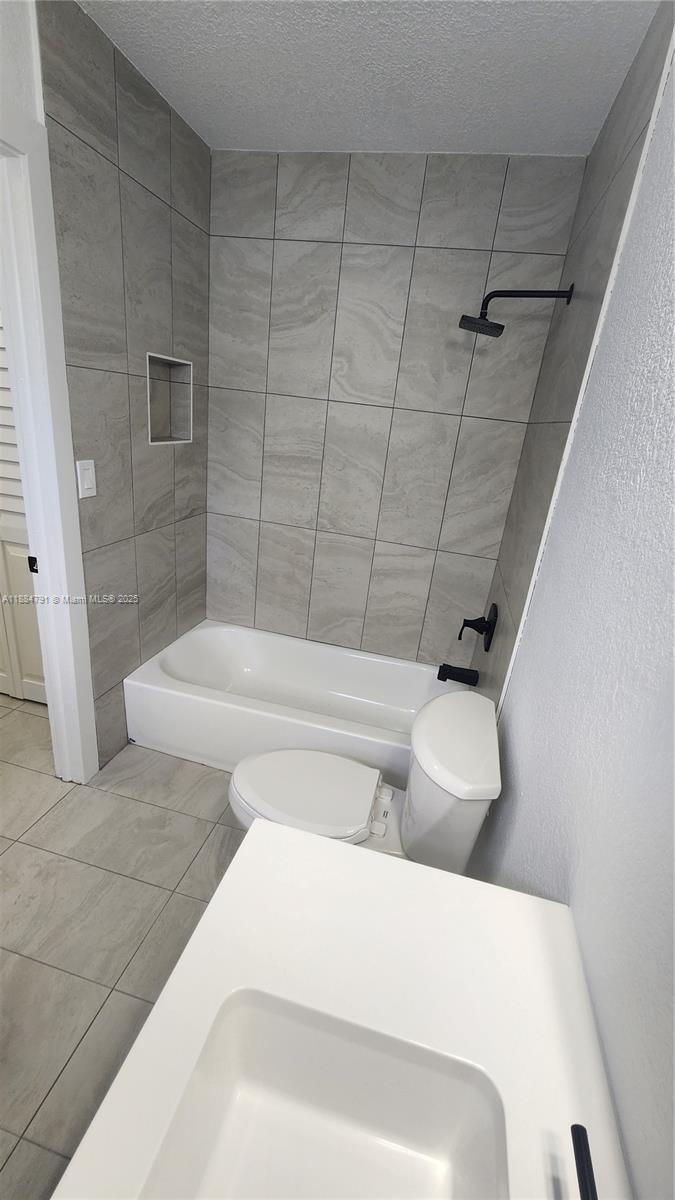 3295 Northwest 214th Street, Unit 3295 Miami Gardens, FL 33056 - Photo 13 of 19 a bathroom with a bathtub and shower