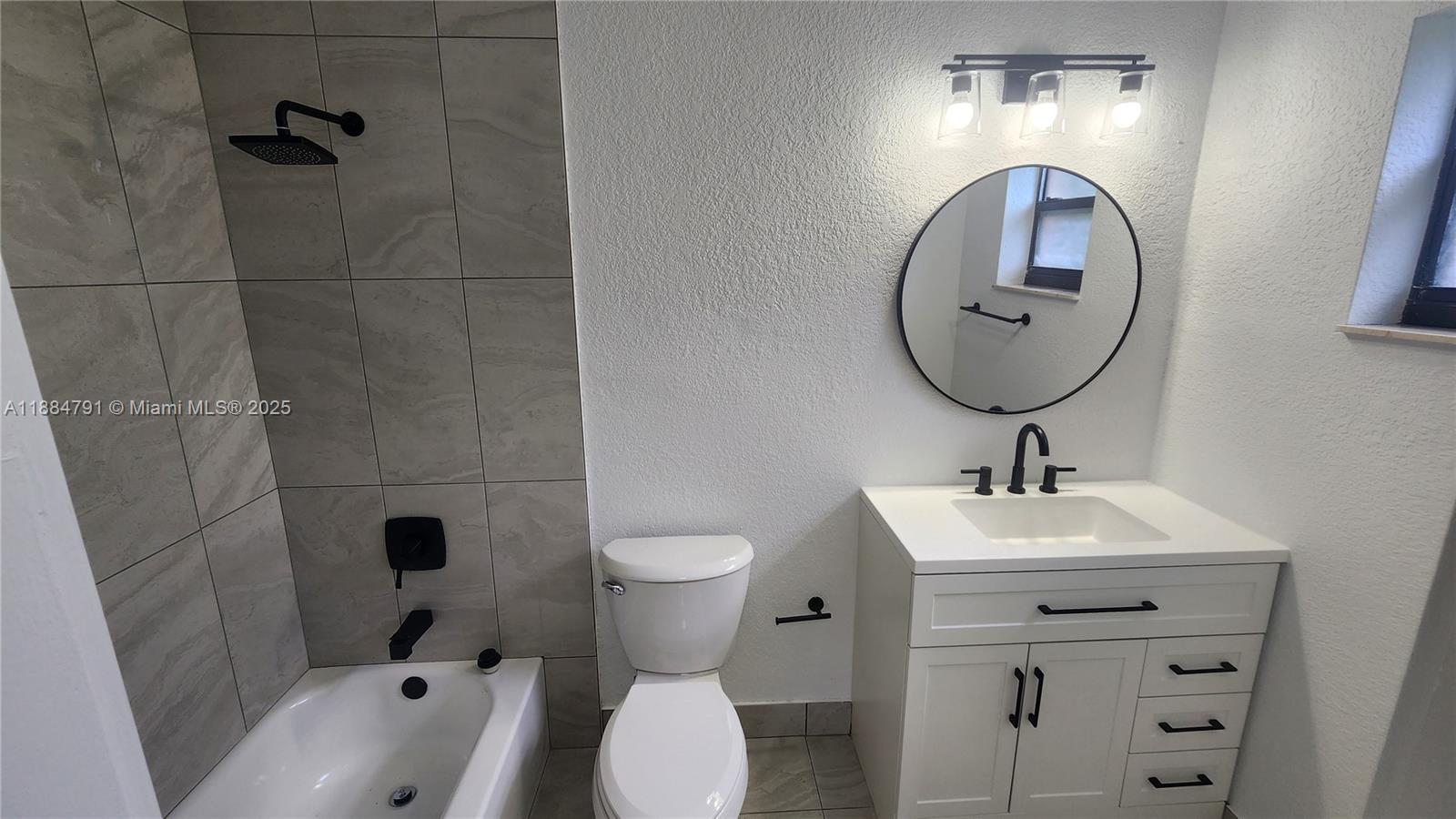 3295 Northwest 214th Street, Unit 3295 Miami Gardens, FL 33056 - Photo 17 of 19 a bathroom with a toilet sink and mirror
