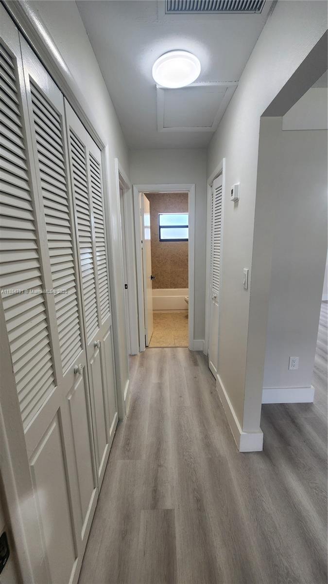 3295 Northwest 214th Street, Unit 3295 Miami Gardens, FL 33056 - Photo 9 of 19 wooden floor in a gallery