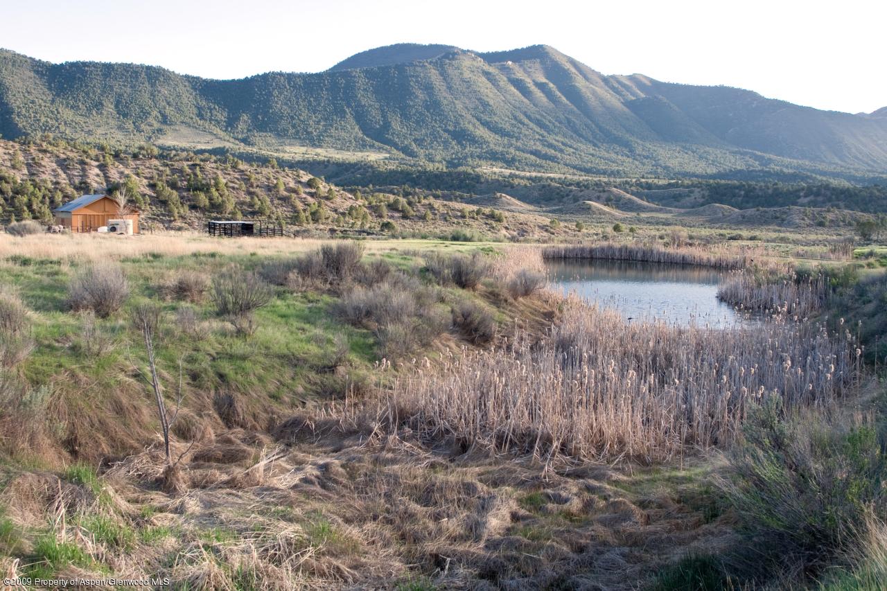 1225 County Road 226 Rifle, CO 81650 - Photo 14 of 22 a view of a lake with mountains in the background