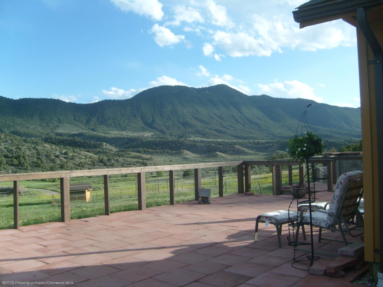 1225 County Road 226 Rifle, CO 81650 - Photo 22 of 22 a view of a patio with table and chairs with wooden fence and floor