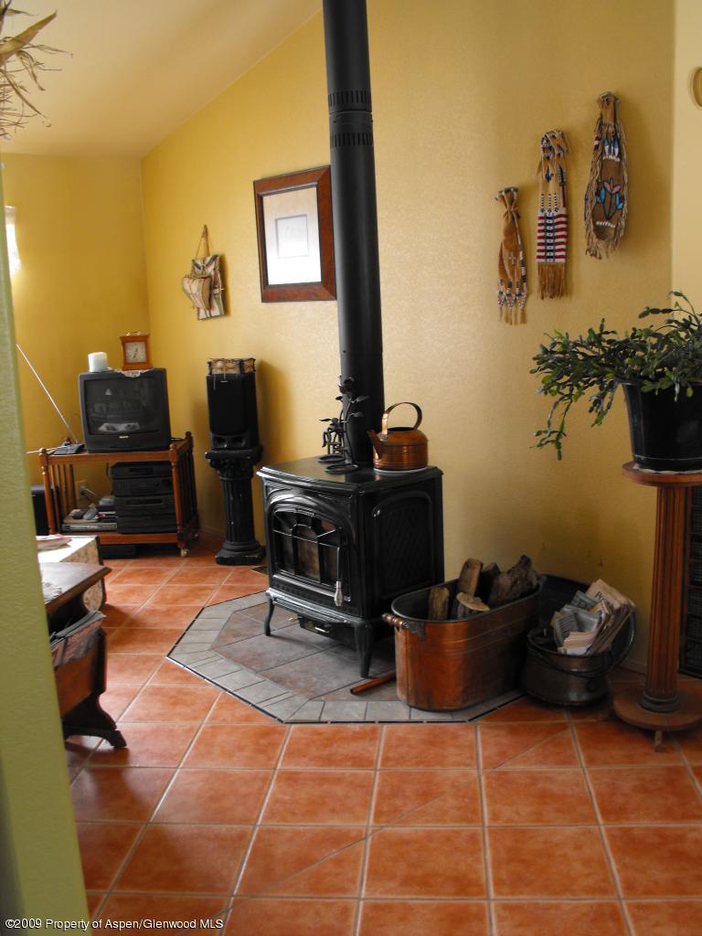 1225 County Road 226 Rifle, CO 81650 - Photo 6 of 22 a living room with furniture a flat screen tv and a fireplace
