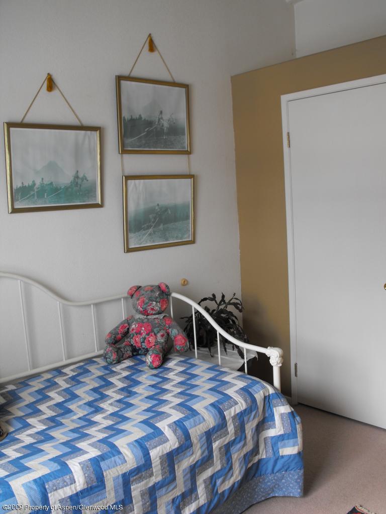 1225 County Road 226 Rifle, CO 81650 - Photo 10 of 22 a bedroom with a bed and a painting on the wall