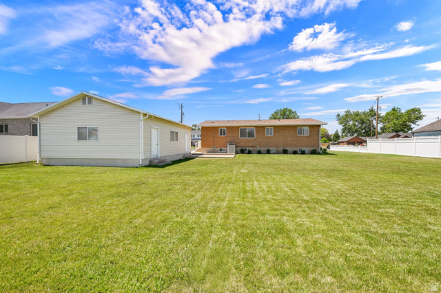 2467 South 2000 West Syracuse, UT 84075 - Photo 26 of 28 Expansive green lawn with a vinyl privacy fence
