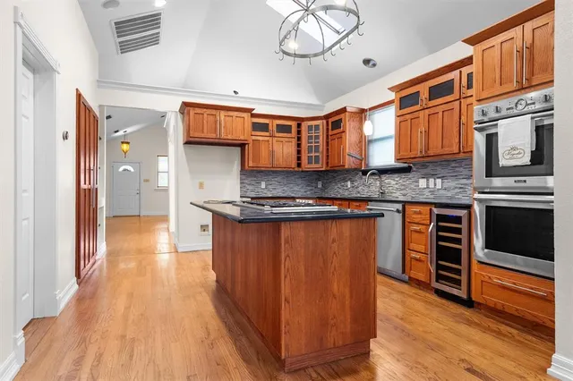 a kitchen with stainless steel appliances granite countertop a stove and cabinets