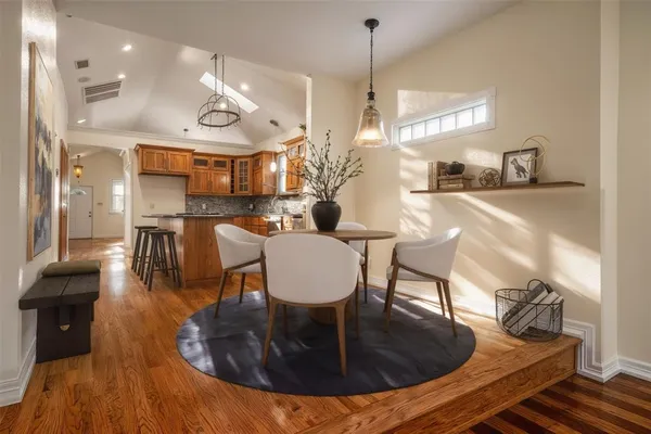 a dining room with furniture a large window and kitchen view