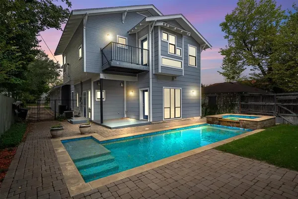a view of a house with swimming pool and sitting area