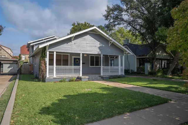 a front view of a house with a garden and porch