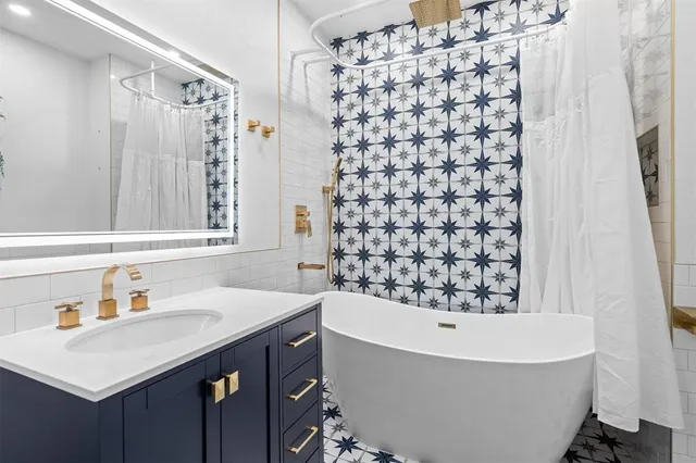 a bathroom with a bathtub and shower