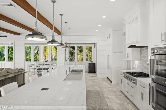 a living room with furniture a flat screen tv and a large window