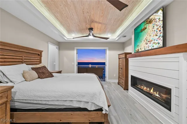 a bedroom with a bed a fireplace and a window